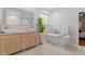 Spa-like bathroom features a soaking tub, dual vanities, and a stylish, modern design at 528 Clifton Blue St, Wake Forest, NC 27587