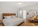Bright and airy bedroom with hardwood floors, a sitting area, and tasteful decor at 528 Clifton Blue St, Wake Forest, NC 27587