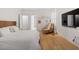 Serene bedroom featuring minimalist decor, a television, and hardwood flooring at 528 Clifton Blue St, Wake Forest, NC 27587