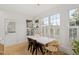 Dining area features modern lighting, a marble table, and large windows with plantation shutters at 528 Clifton Blue St, Wake Forest, NC 27587