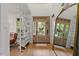 Bright foyer featuring a wood door with glass, hardwood floors, white walls, and a decorative mirror at 528 Clifton Blue St, Wake Forest, NC 27587
