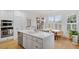 Bright kitchen with an island, modern appliances, and a dining area with lots of natural light at 528 Clifton Blue St, Wake Forest, NC 27587