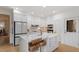 Bright kitchen features white cabinets, stainless steel appliances, and a large island with seating at 528 Clifton Blue St, Wake Forest, NC 27587