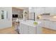 Modern kitchen boasts white cabinetry, stainless appliances, and a center island with seating at 528 Clifton Blue St, Wake Forest, NC 27587