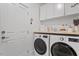 Well-lit laundry room featuring front loading LG washer and dryer and crisp white cabinets at 528 Clifton Blue St, Wake Forest, NC 27587