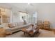 Open-concept living room featuring a large sofa, stylish decor, and hardwood floors at 528 Clifton Blue St, Wake Forest, NC 27587
