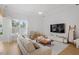 Bright living room featuring a comfortable sofa, modern decor, and abundant natural light at 528 Clifton Blue St, Wake Forest, NC 27587