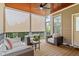 Screened-in porch with comfortable seating, ceiling fan, and views of the surrounding landscape at 528 Clifton Blue St, Wake Forest, NC 27587