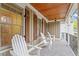 Inviting covered porch with stained wood ceiling, ceiling fan and comfortable white rocking chairs at 528 Clifton Blue St, Wake Forest, NC 27587