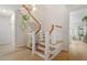 Elegant staircase with wood and white finishes, complemented by stylish decor and ample natural light at 528 Clifton Blue St, Wake Forest, NC 27587