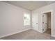 Neutral-toned bedroom with carpet, natural light, and a closet entrance at 520 Folk Song Way, Wendell, NC 27591