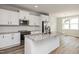 Well-lit kitchen featuring granite countertops, stainless steel appliances, and white cabinetry at 520 Folk Song Way, Wendell, NC 27591