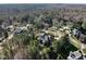 Aerial view of a luxury home surrounded by mature trees in a desirable neighborhood at 5768 Cavanaugh Dr, Raleigh, NC 27614