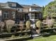 Multi-tiered backyard boasts a screened porch, stone patio with outdoor seating, and manicured landscaping at 5768 Cavanaugh Dr, Raleigh, NC 27614
