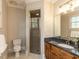 Comfortable bathroom with a glass door shower, vanity, mirror, and toilet at 5768 Cavanaugh Dr, Raleigh, NC 27614