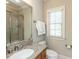 Inviting bathroom with a vanity, toilet, mirror, window, and a walk-in shower with a glass door at 5768 Cavanaugh Dr, Raleigh, NC 27614