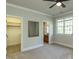 Neutral bedroom with a window, mirror, walk-in closet, and a door to the bathroom at 5768 Cavanaugh Dr, Raleigh, NC 27614