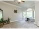 Bedroom offers neutral carpet, arched window with work station and an elegant ceiling fan at 5768 Cavanaugh Dr, Raleigh, NC 27614