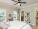 Light filled bedroom with a comfortable bed, mirror, two windows, and access to the bathroom and walk-in closet at 5768 Cavanaugh Dr, Raleigh, NC 27614