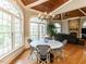 Bright breakfast nook with round table, wood ceiling, large windows and view of living room at 5768 Cavanaugh Dr, Raleigh, NC 27614