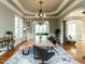 Bright dining room with long wooden table, decorative chandelier, and hardwood floors at 5768 Cavanaugh Dr, Raleigh, NC 27614