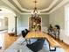 Dining room with a modern light fixture and a large wooden table at 5768 Cavanaugh Dr, Raleigh, NC 27614