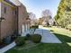 Brick home with a long driveway and attached three-car garage, surrounded by mature trees and green landscaping at 5768 Cavanaugh Dr, Raleigh, NC 27614