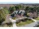 Beautiful two-story brick home with a circular driveway, mature trees, and professionally landscaped grounds at 5768 Cavanaugh Dr, Raleigh, NC 27614