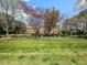 Expansive red brick home with mature trees and lawn at 5768 Cavanaugh Dr, Raleigh, NC 27614