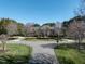 Stately home with a circular drive, mature trees, and manicured lawn at 5768 Cavanaugh Dr, Raleigh, NC 27614