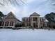 Beautiful brick home with snow covered lawn and mature trees at 5768 Cavanaugh Dr, Raleigh, NC 27614