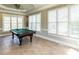 Spacious game room with a pool table and natural light at 5768 Cavanaugh Dr, Raleigh, NC 27614