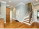 Inviting foyer boasts hardwood floors, staircase with ornate ironwork and classic trim at 5768 Cavanaugh Dr, Raleigh, NC 27614