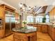 Gourmet kitchen features granite countertops, stainless appliances and a large island with seating at 5768 Cavanaugh Dr, Raleigh, NC 27614