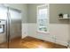 Bright eat-in kitchen with stainless steel refrigerator and a large window offering outdoor views at 5768 Cavanaugh Dr, Raleigh, NC 27614