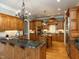 Large kitchen with wood cabinets, granite countertops, stainless steel appliances, and a center island at 5768 Cavanaugh Dr, Raleigh, NC 27614