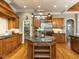 Gourmet kitchen with granite countertops, stainless steel appliances, and custom wood cabinetry at 5768 Cavanaugh Dr, Raleigh, NC 27614