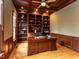 Wood-paneled office featuring built-in bookshelves and a large desk at 5768 Cavanaugh Dr, Raleigh, NC 27614