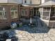 Backyard featuring a custom outdoor kitchen, dining area, and screened-in porch with stone patio at 5768 Cavanaugh Dr, Raleigh, NC 27614