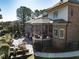 Outdoor living area includes a screened porch, stone patio, built-in grill, and lush landscaping at 5768 Cavanaugh Dr, Raleigh, NC 27614