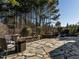 Spacious outdoor patio features a stone fire pit, seating, and stone walls for entertaining guests at 5768 Cavanaugh Dr, Raleigh, NC 27614