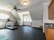 Open recreation room featuring gym equipment, rubber floor, and natural light from windows at 5768 Cavanaugh Dr, Raleigh, NC 27614