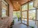 Enjoy the outdoors from this screened porch with wood ceiling and brick accents at 5768 Cavanaugh Dr, Raleigh, NC 27614