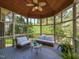 Relaxing screened-in porch with comfortable seating and a peaceful view of the surrounding trees at 5768 Cavanaugh Dr, Raleigh, NC 27614