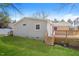 View of the backyard featuring a well-maintained lawn and a wooden deck at 6 Hawaii Ct, Durham, NC 27713