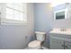 Charming half-bathroom features a toilet, sink, and a gray cabinet for storage at 6 Hawaii Ct, Durham, NC 27713