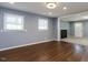 Bright living room features hardwood floors and ample natural light from two windows with blinds at 6 Hawaii Ct, Durham, NC 27713