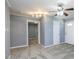 Inviting living room with neutral carpet, a ceiling fan, and a brick wall adjacent to the entry at 6 Hawaii Ct, Durham, NC 27713