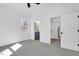 Spacious bedroom with soft carpet and doorways to a bathroom and closet at 604 E Pope St, Dunn, NC 28334