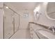 Bright bathroom with double sinks, granite countertop, glass shower, and patterned tile flooring at 608 Hemlock Ave, Durham, NC 27707